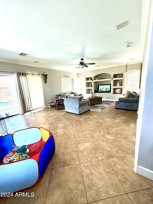 tiled living room featuring ornamental molding, a textured ceiling, built in features, and ceiling fan