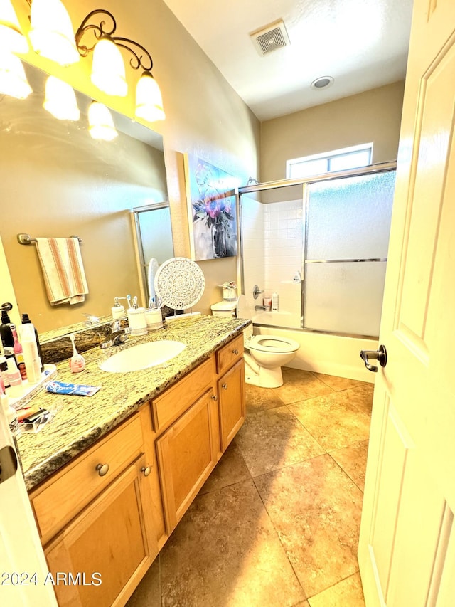 full bathroom with vanity, shower / bath combination with glass door, and toilet