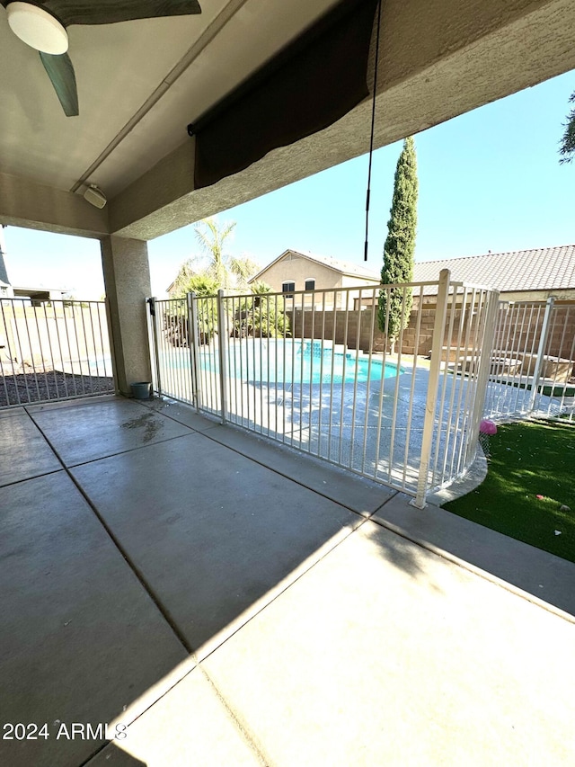 view of patio featuring a covered pool and ceiling fan