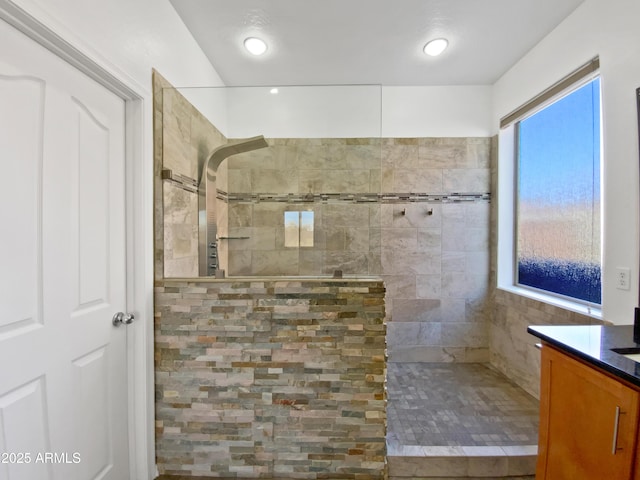 full bathroom with walk in shower and vanity