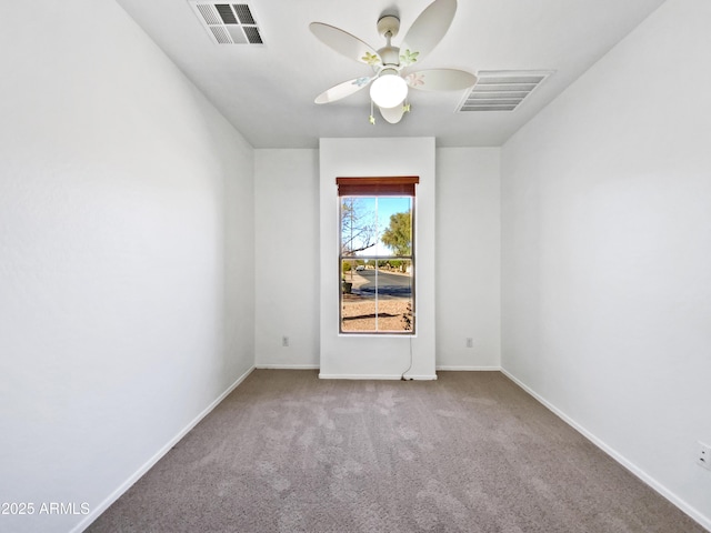 spare room featuring baseboards, carpet, visible vents, and ceiling fan