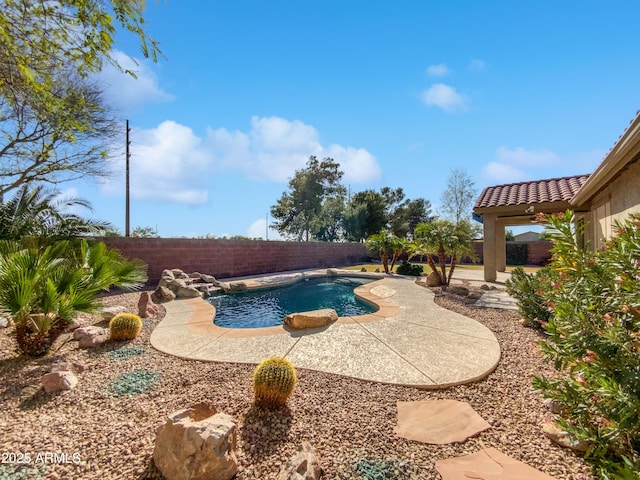 view of swimming pool with a fenced backyard, a fenced in pool, and a patio