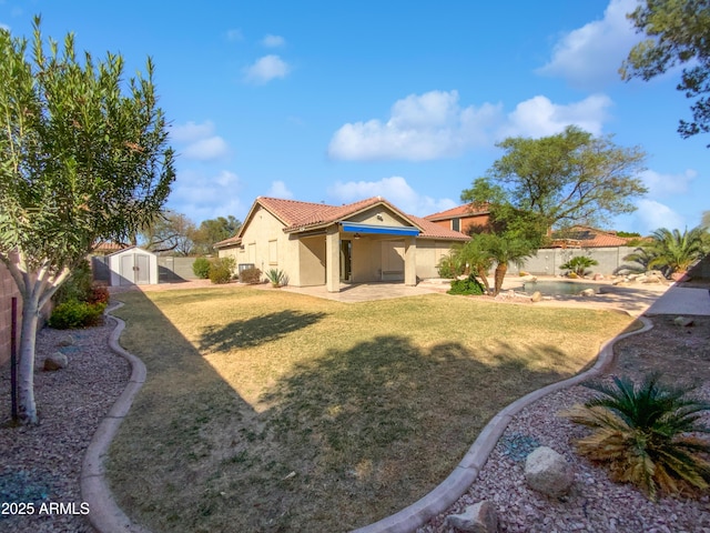 view of yard with an outbuilding, a storage unit, a fenced backyard, and a patio area