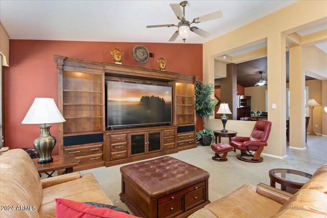 carpeted living room with lofted ceiling and ceiling fan