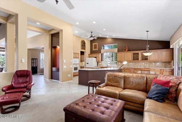 living room featuring high vaulted ceiling, ceiling fan, and light tile patterned floors