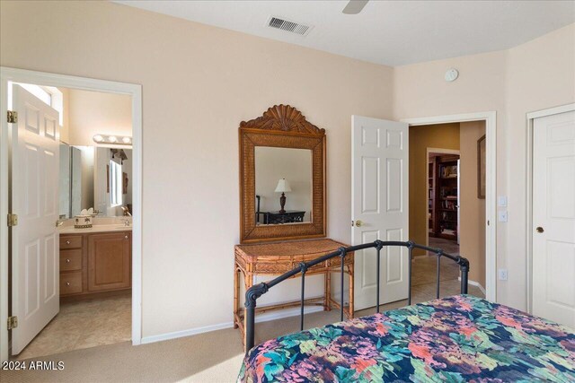 tiled bedroom with connected bathroom and ceiling fan