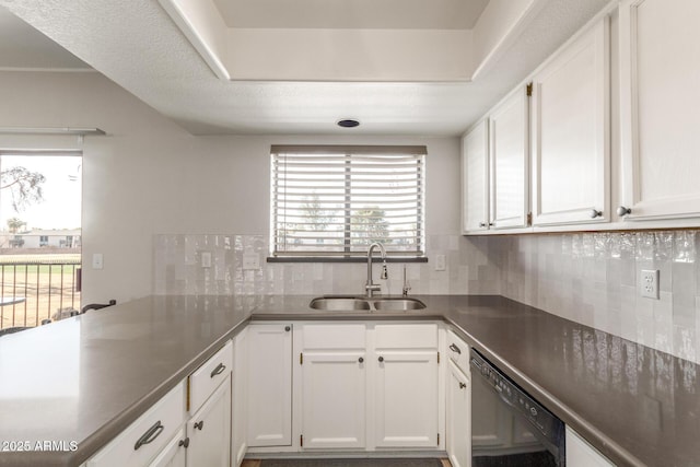 kitchen featuring a wealth of natural light, white cabinetry, dishwasher, and sink