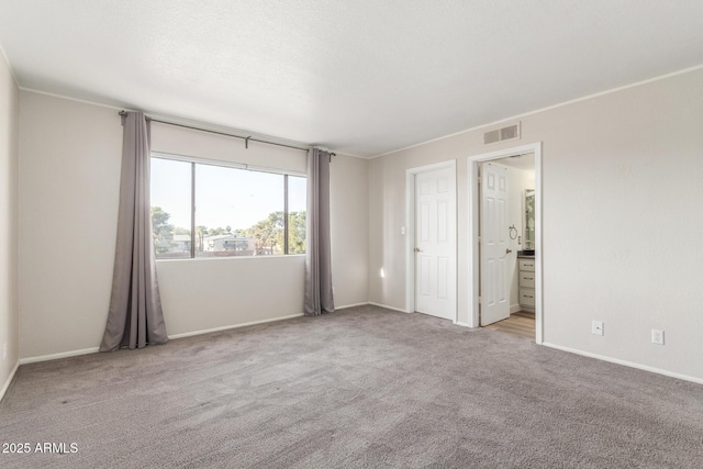 spare room featuring light colored carpet