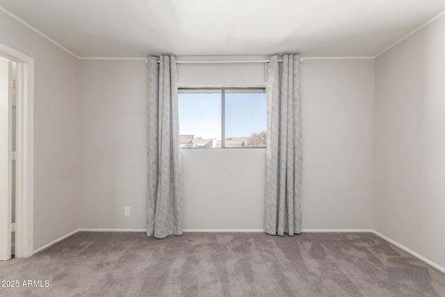 unfurnished room featuring light carpet