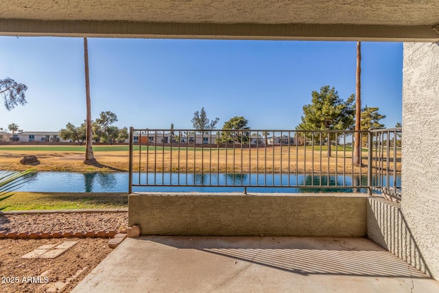 view of pool featuring a water view and a yard