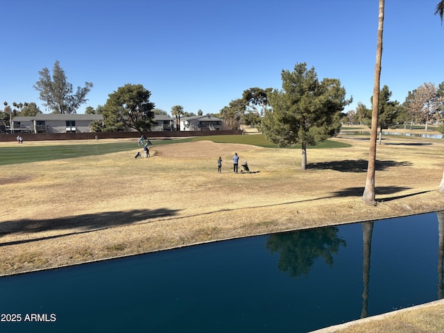 view of community with a water view and a lawn