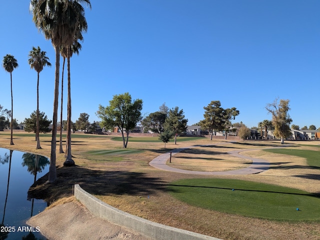 view of community with a water view and a yard