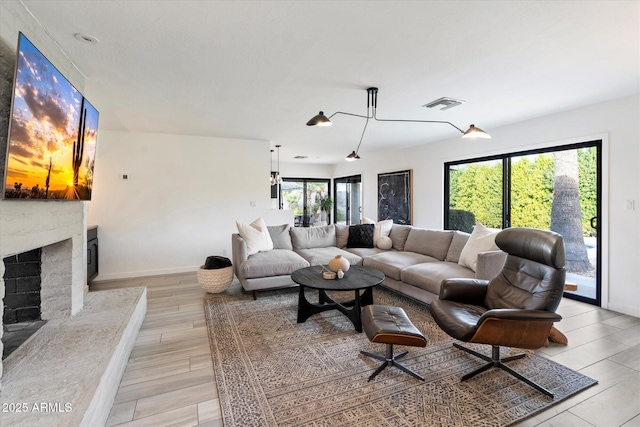 living room with a fireplace and a healthy amount of sunlight