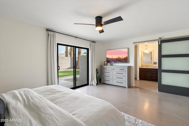 bedroom featuring ceiling fan, a barn door, access to outside, and ensuite bath