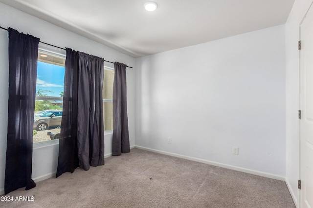 unfurnished room featuring light colored carpet