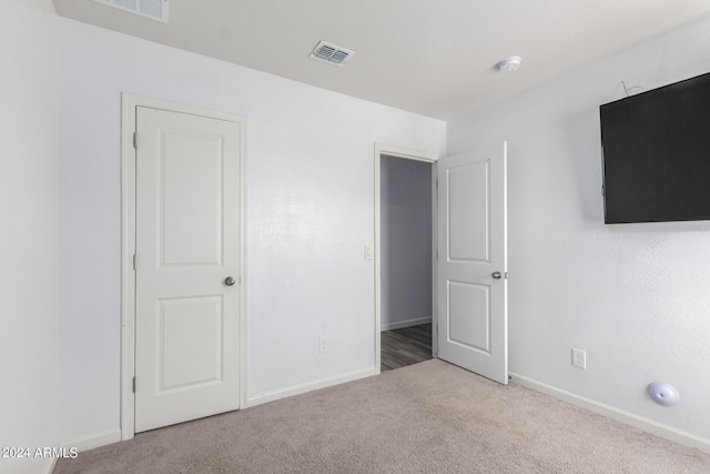 unfurnished bedroom with light carpet