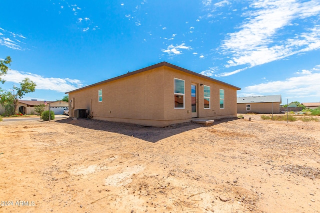 view of side of home with central AC unit