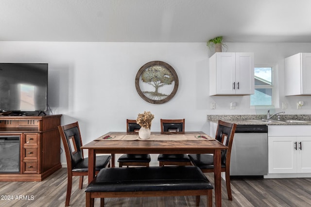 dining room with hardwood / wood-style floors and sink