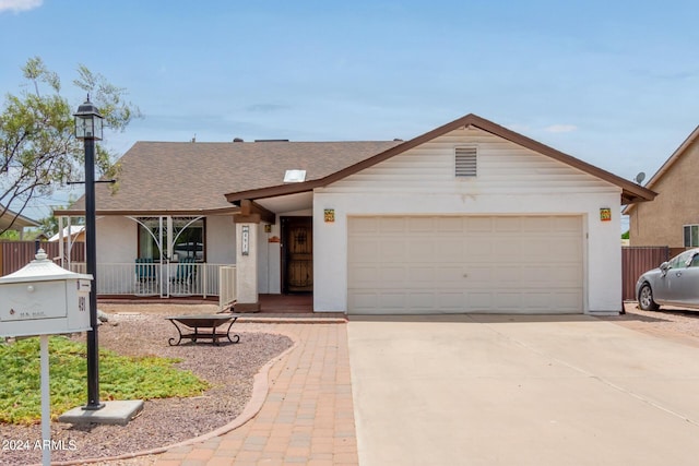 single story home featuring a porch and a garage