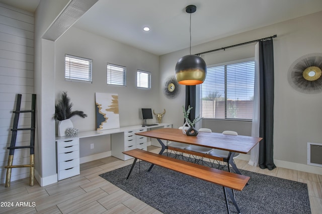 dining room featuring light wood-type flooring and a wealth of natural light