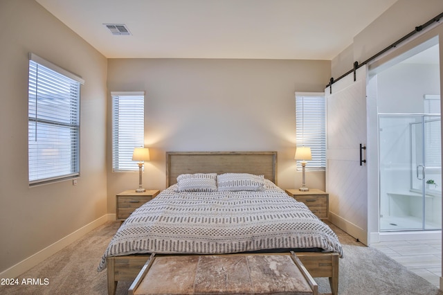 carpeted bedroom with a barn door