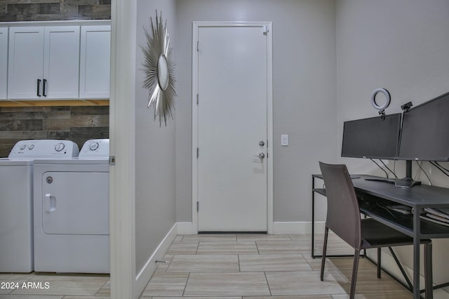 clothes washing area featuring cabinets and independent washer and dryer