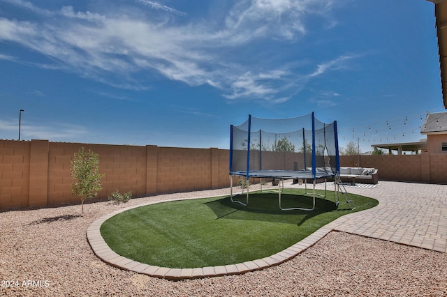 view of yard with an outdoor hangout area, a trampoline, and a patio