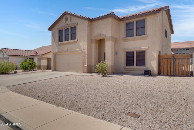 mediterranean / spanish-style house with a garage