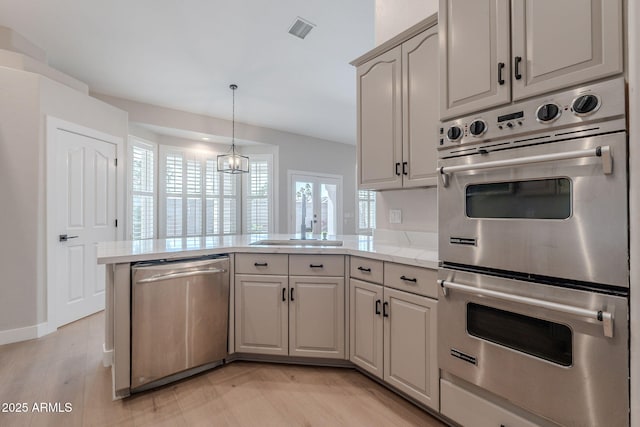 1062 N Robin Ln, Mesa, AZ 85213 - kitchen with appliances with stainless steel finishes, a peninsula, a sink, pendant lighting, and light stone counters