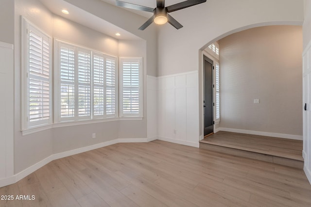 1062 N Robin Ln, Mesa, AZ 85213 - spare room featuring arched walkways, a ceiling fan, light wood-type flooring, recessed lighting, and baseboards