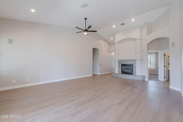 1062 N Robin Ln, Mesa, AZ 85213 - unfurnished living room with a ceiling fan, baseboards, a tile fireplace, recessed lighting, and arched walkways