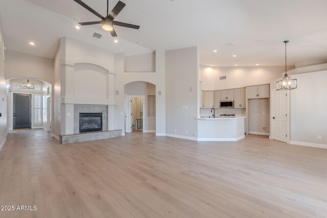 1062 N Robin Ln, Mesa, AZ 85213 - unfurnished living room with ceiling fan, a sink, high vaulted ceiling, baseboards, and light wood finished floors