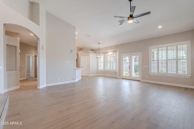 1062 N Robin Ln, Mesa, AZ 85213 - unfurnished living room featuring ceiling fan, arched walkways, baseboards, light wood-type flooring, and recessed lighting