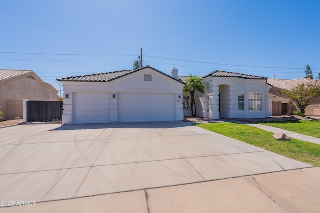 1062 N Robin Ln, Mesa, AZ 85213 - mediterranean / spanish house featuring concrete driveway, a garage, a tiled roof, and stucco siding