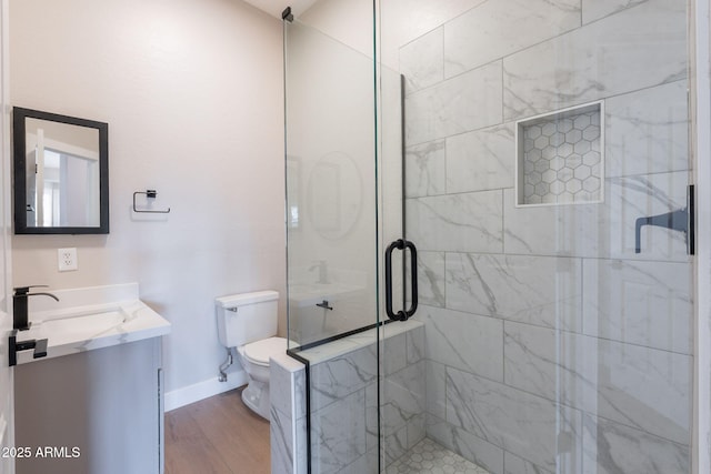 1062 N Robin Ln, Mesa, AZ 85213 - bathroom with vanity, toilet, a shower stall, wood finished floors, and baseboards