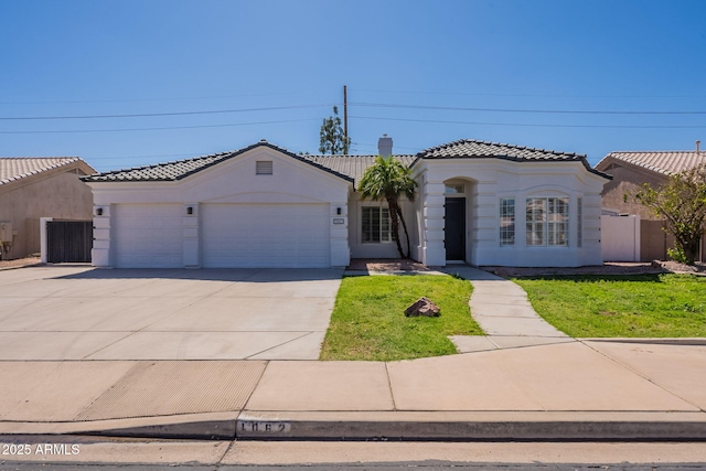 1062 N Robin Ln, Mesa, AZ 85213 - mediterranean / spanish-style home with a tiled roof, a garage, concrete driveway, and stucco siding