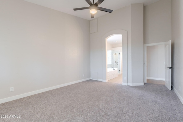 1062 N Robin Ln, Mesa, AZ 85213 - spare room with arched walkways, light colored carpet, a ceiling fan, and baseboards