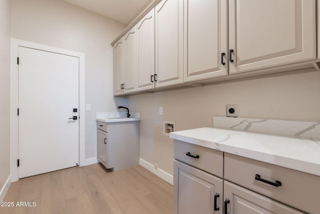 1062 N Robin Ln, Mesa, AZ 85213 - laundry room featuring cabinet space, light wood-style flooring, hookup for a washing machine, electric dryer hookup, and baseboards