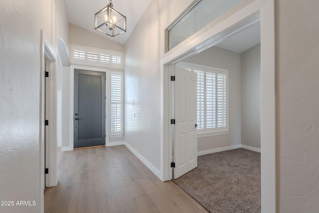 1062 N Robin Ln, Mesa, AZ 85213 - foyer entrance with a chandelier, wood finished floors, lofted ceiling, and baseboards