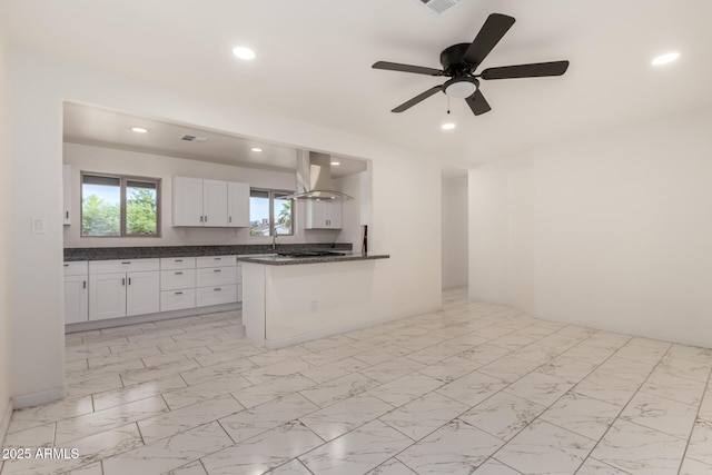1644 W Mountain View Rd, Phoenix, AZ 85021 - kitchen featuring dark countertops, island range hood, white cabinetry, recessed lighting, and ceiling fan