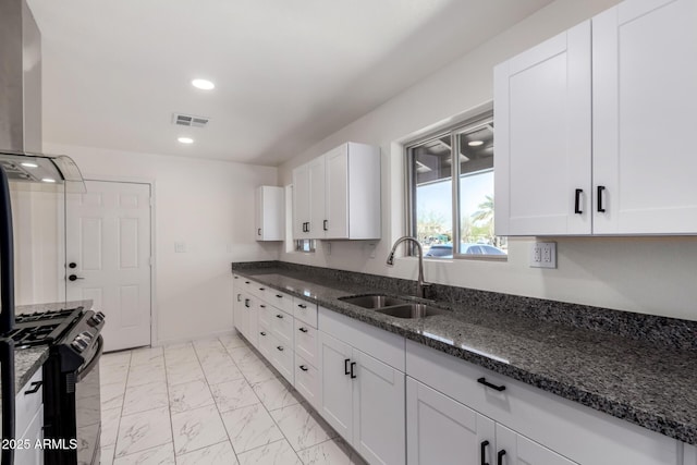 1644 W Mountain View Rd, Phoenix, AZ 85021 - kitchen featuring a sink, black gas range, light marble finish flooring, white cabinets, and dark stone counters