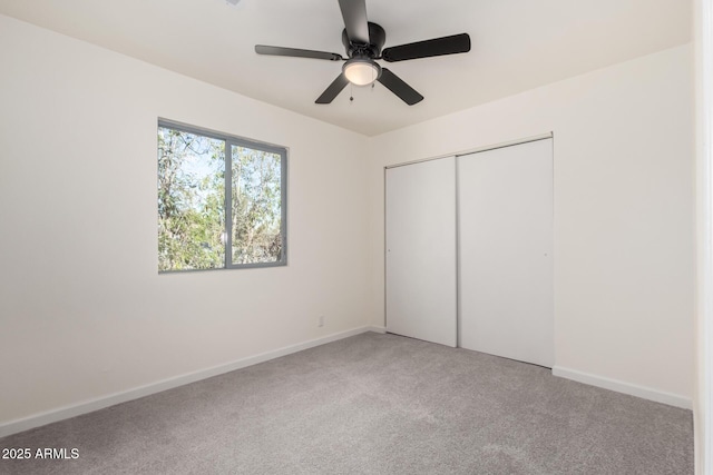 1644 W Mountain View Rd, Phoenix, AZ 85021 - unfurnished bedroom featuring light carpet, a closet, baseboards, and a ceiling fan