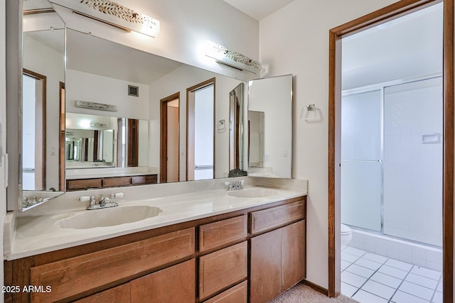 bathroom with toilet, visible vents, a stall shower, and a sink