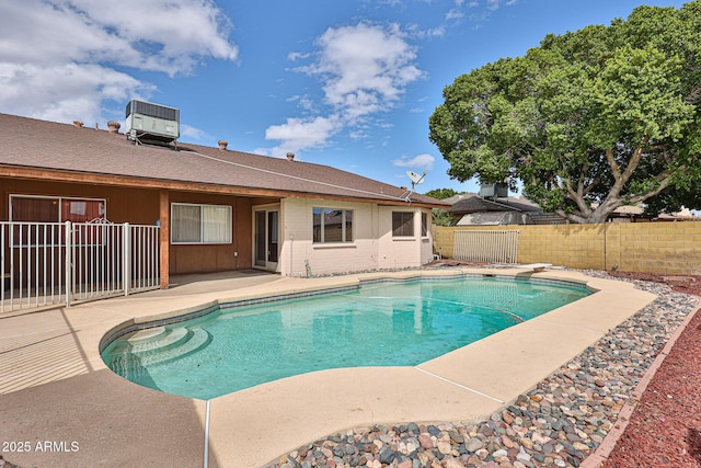 view of pool featuring a patio, a fenced in pool, central AC unit, a fenced backyard, and a diving board