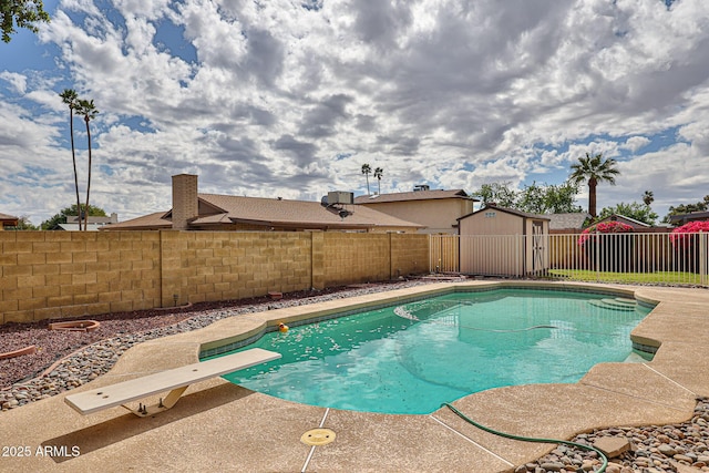 view of swimming pool featuring a fenced in pool, a patio area, a fenced backyard, an outbuilding, and a storage unit