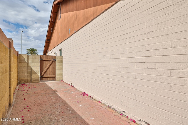 view of side of property with a gate and fence