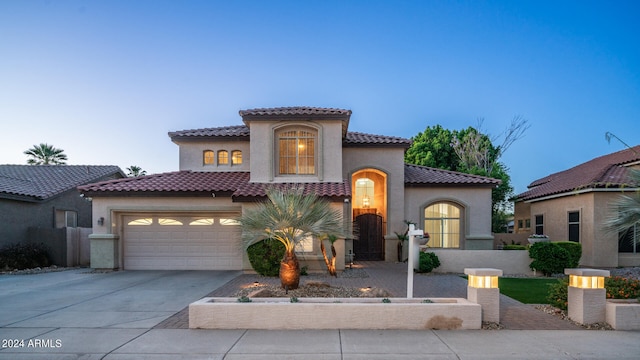 mediterranean / spanish house with a garage