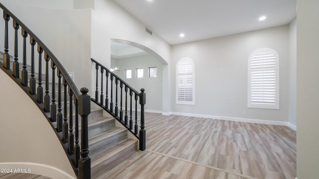 stairway with hardwood / wood-style floors