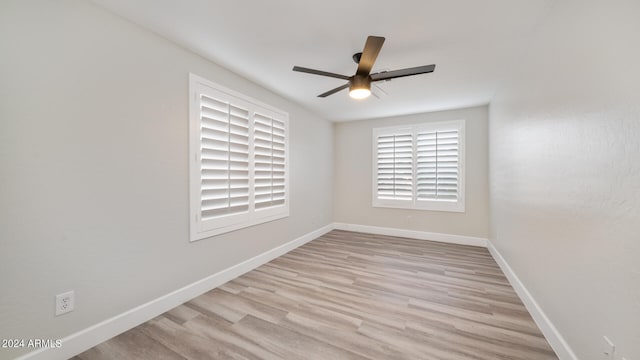 empty room with light hardwood / wood-style flooring and ceiling fan