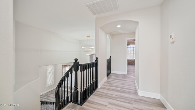 hallway with light hardwood / wood-style floors